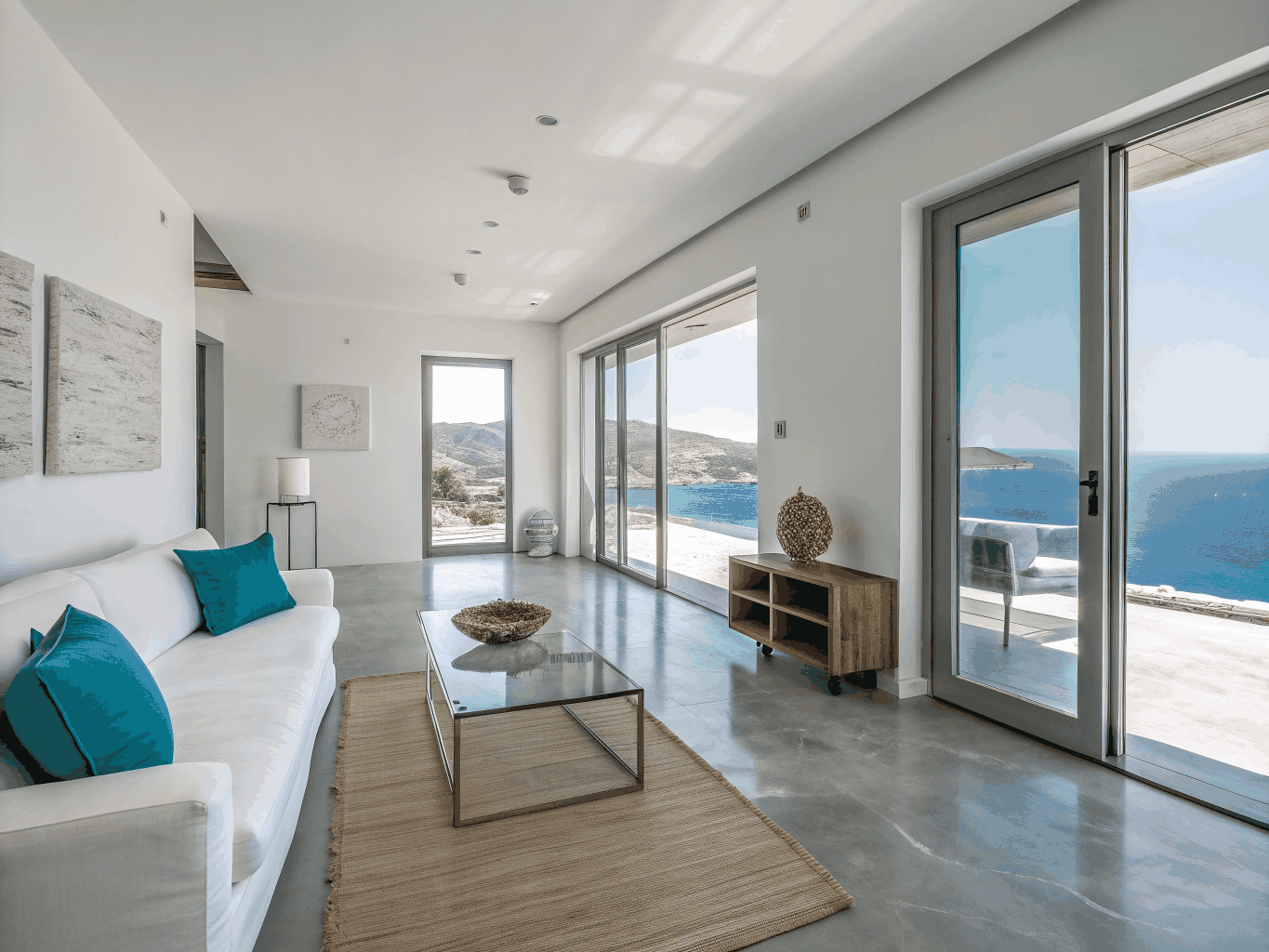 Minimalist luxury suite interior with floor-to-ceiling ocean views